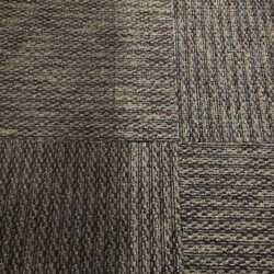 A close-up of a carpet floor showing four rectangular tiles with different linear patterns in shades of brown and beige.